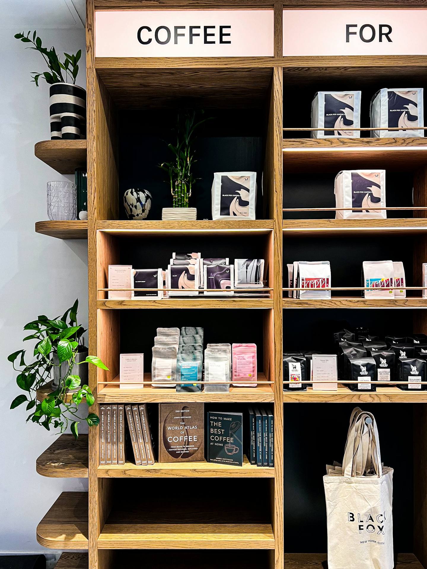 Wooden shelves of coffee bags and books in a local shop