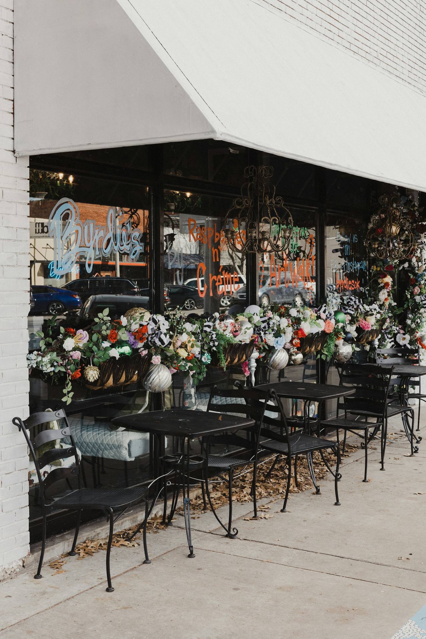 A café terrace overflowing with flowers